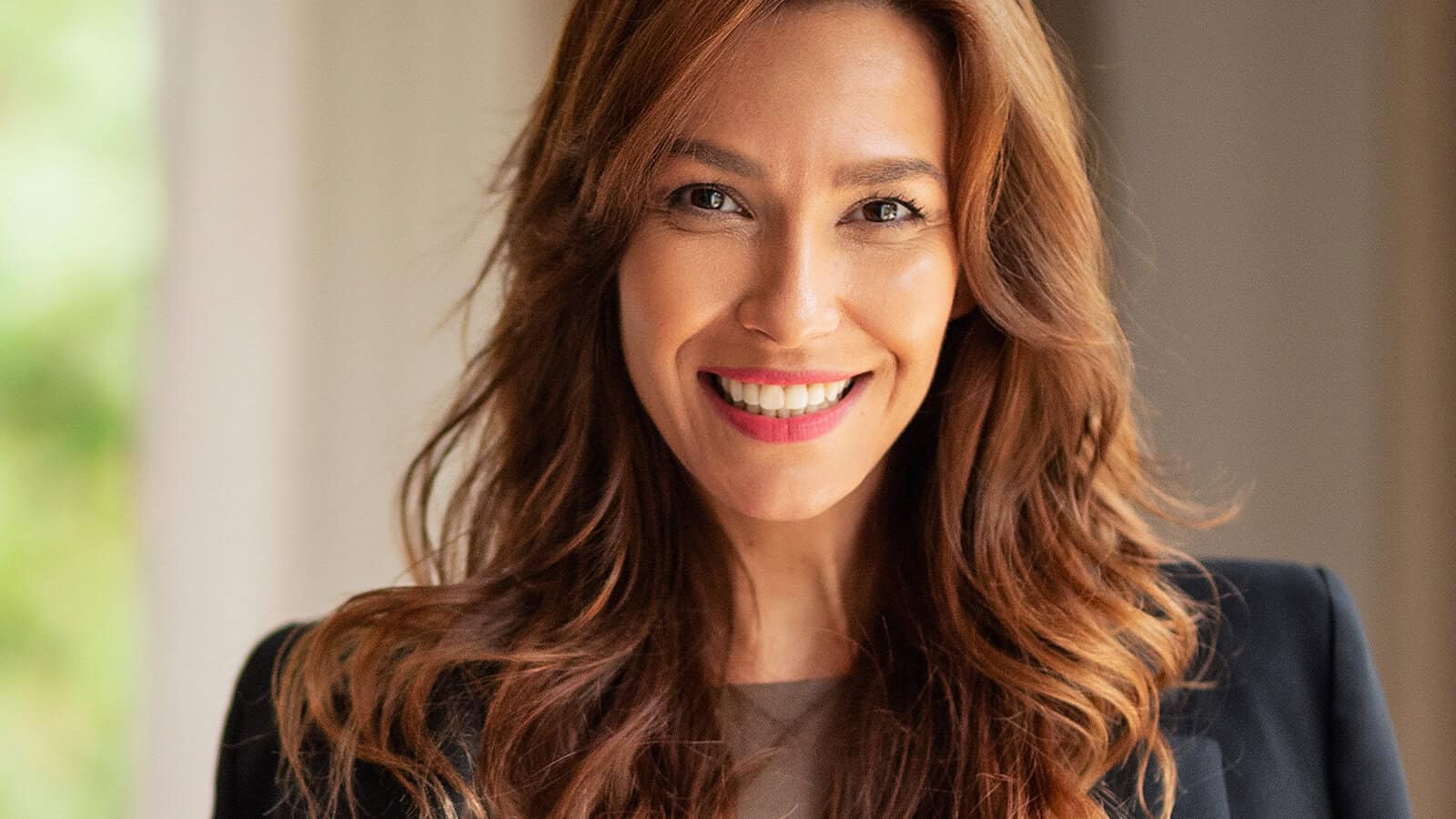 A smiling woman looking directly at the camera.