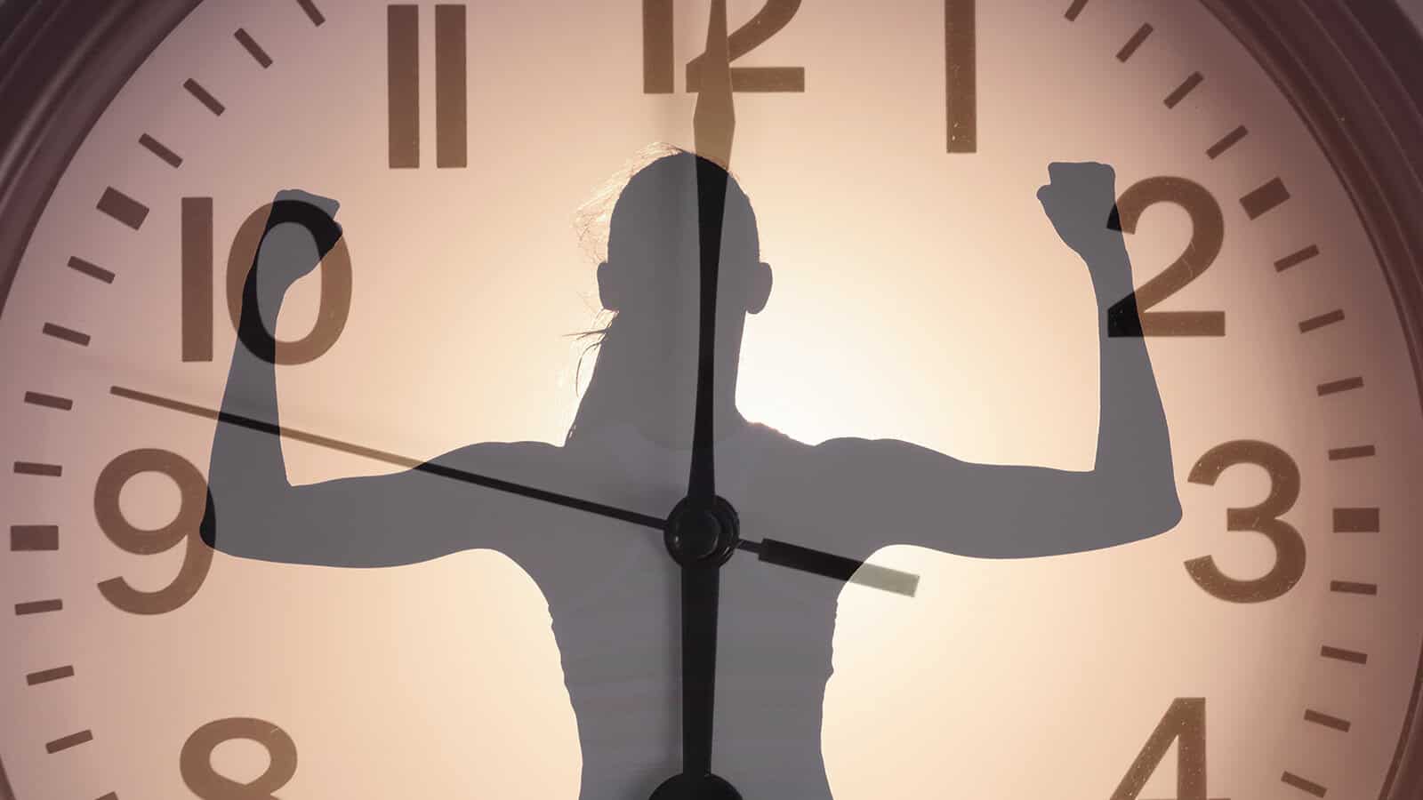A silhouette of a person flexing their arms layered over a large clock face.