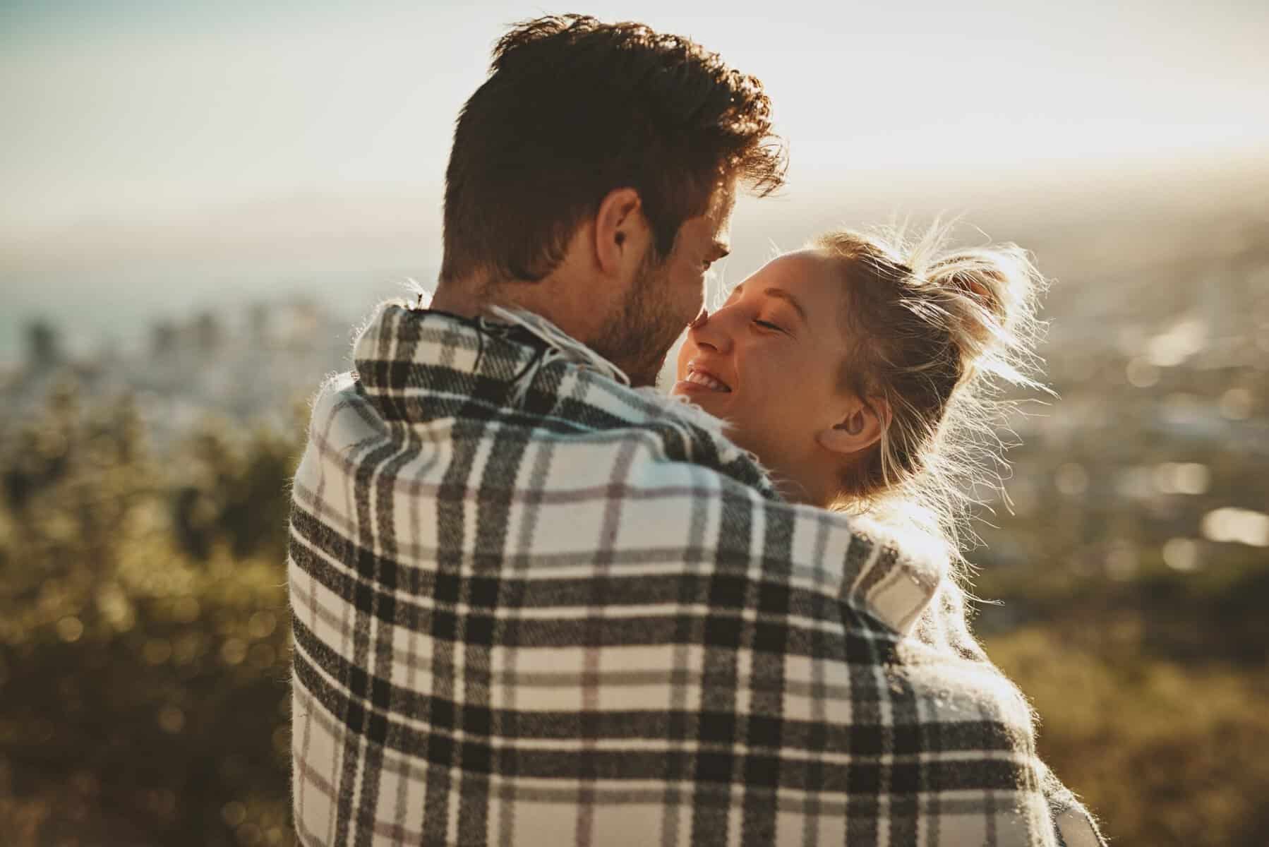 A young couple in love on a walk outdoors.