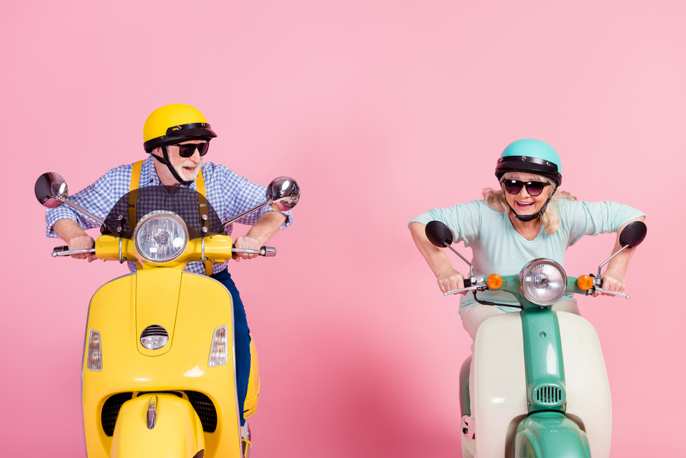 Excited,Funky,Senior husband and wife driving motorbikes