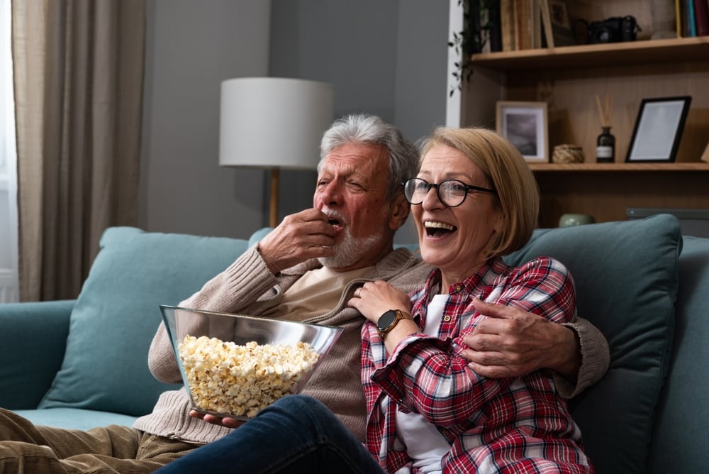 Couple watching TV together.