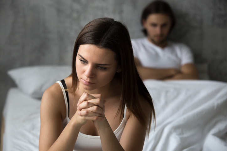 Frustrated sad girlfriend sit on bed think of relationship problems, thoughtful couple after quarrel lost in thoughts, upset lovers consider break up,