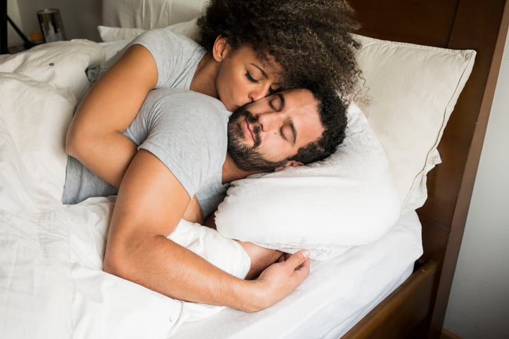 Couple in love, between 30 and 39 years old waking up in their bed, happy, embraced, on a beautiful morning