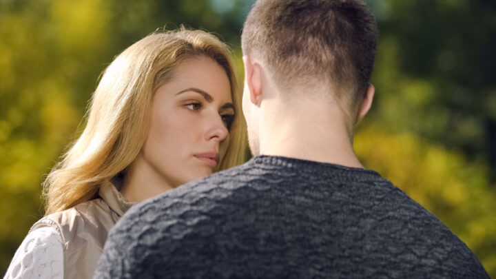 Upset woman looking at man, apologizing after quarrel, misunderstanding problem