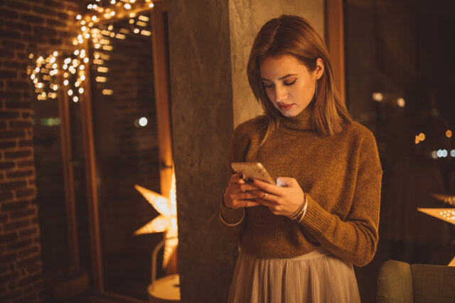 Woman feeling alone at a holiday party. 