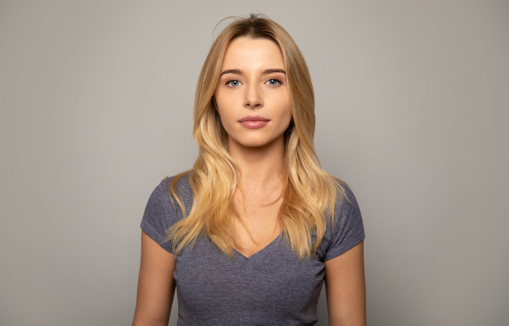 Calm looking woman appearing emotionless or disassociated.