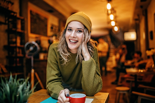 Women drinking coffee alone in coffee shop
