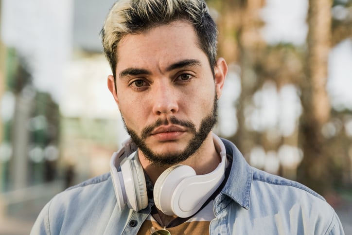 Young man listening to music with headphones.
