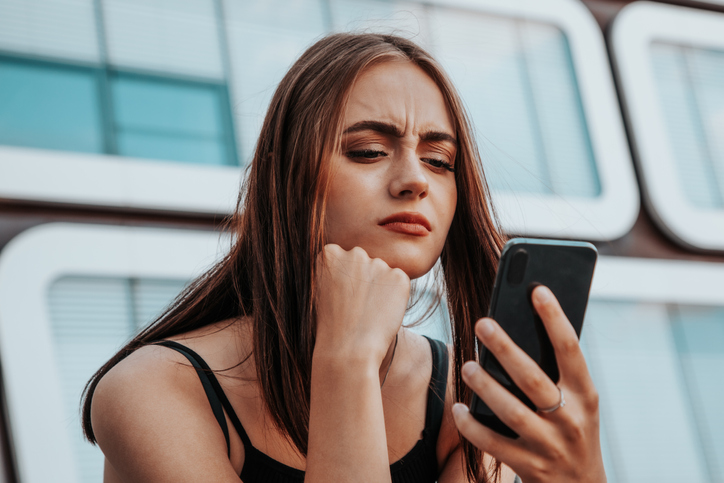 Bad News Young Woman Reading Messages on Mobile Phone