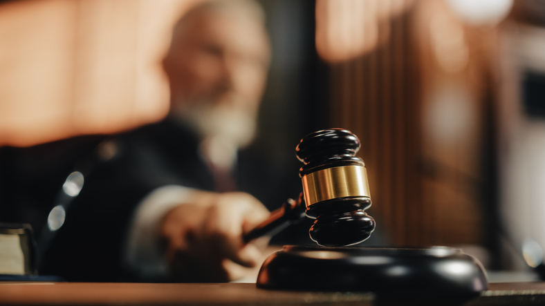 Court of Law judge striking gavel.