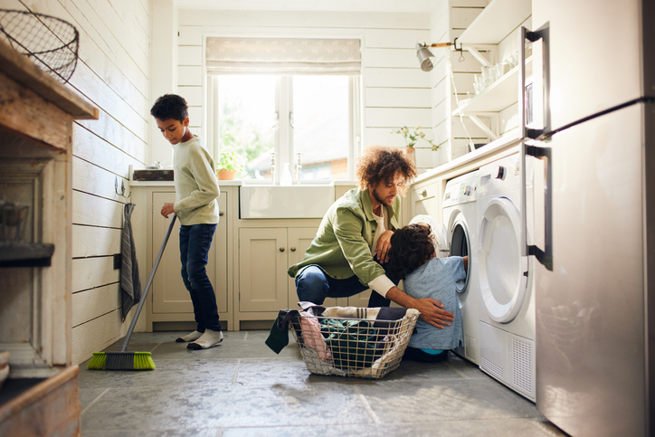 Two boys helping father with household chores