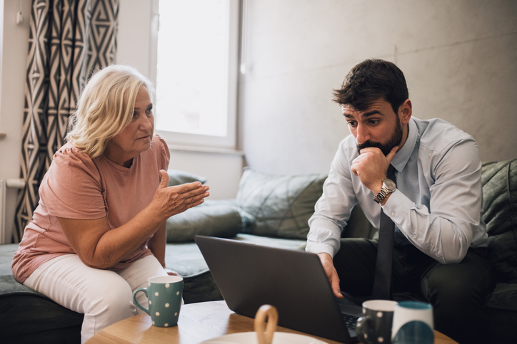 A woman talking to a younger exasperated looking man