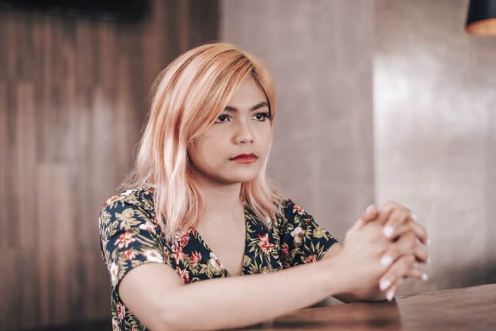 An unhappy young woman with a blank look in her eyes. Hurt and sad from breakup from first relationship