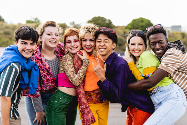 Happy young diverse friends having fun hanging out together.