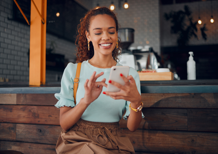 Restaurant, smartphone and relax black happy woman typing, scroll or check email, contact social media app or social network user. Happy, smile and young gen z girl with mobile tech post to online web blog