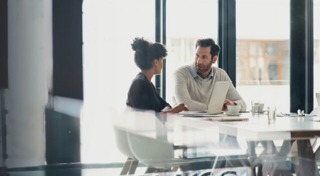 Businesspeople in meeting, planning strategy in conference room, sharing ideas and teamwork.