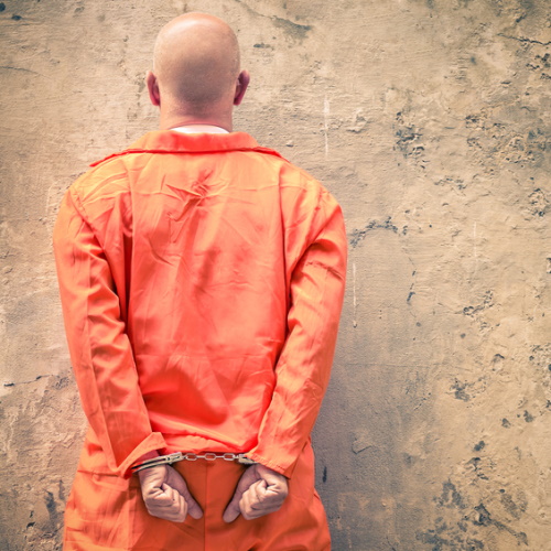 Handcuffed Prisoner in jail.