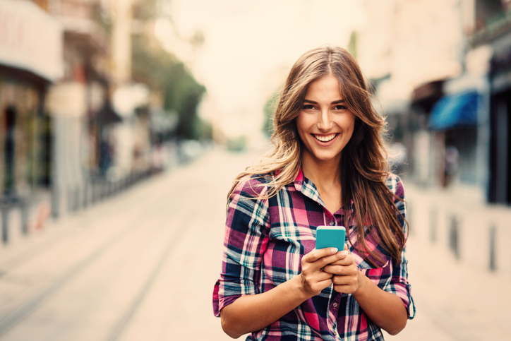 Young woman texting on the phone