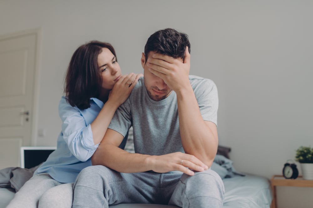 A woman consoling her boyfriend
