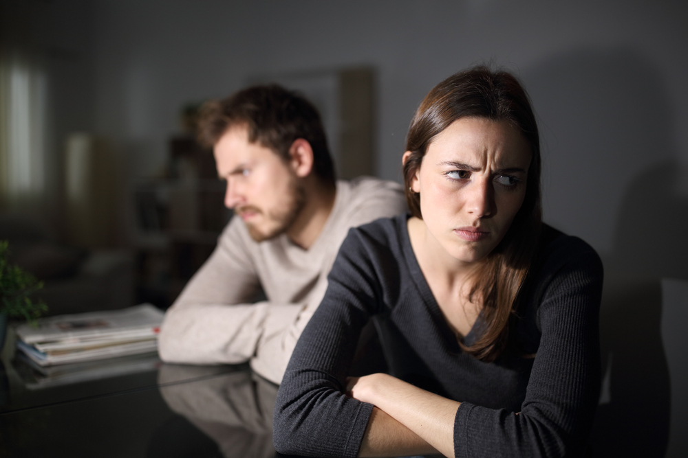 An upset young couple having a disagreement.