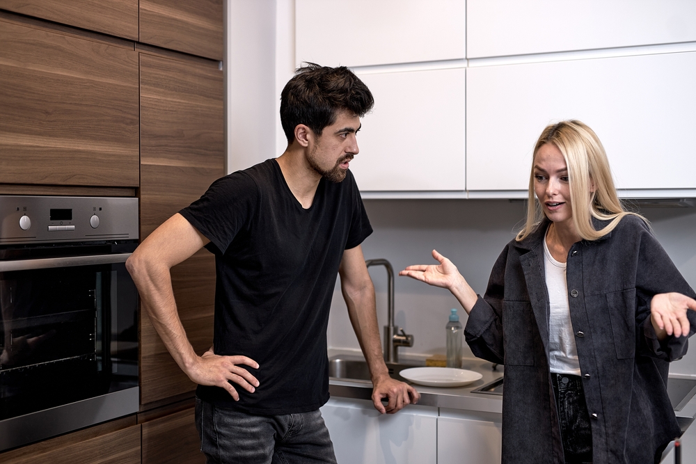 Tired frustrated wife arguing with her husband and proceeds to ignore him