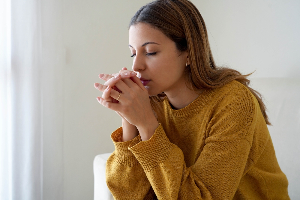 A woman sitting alone at home.