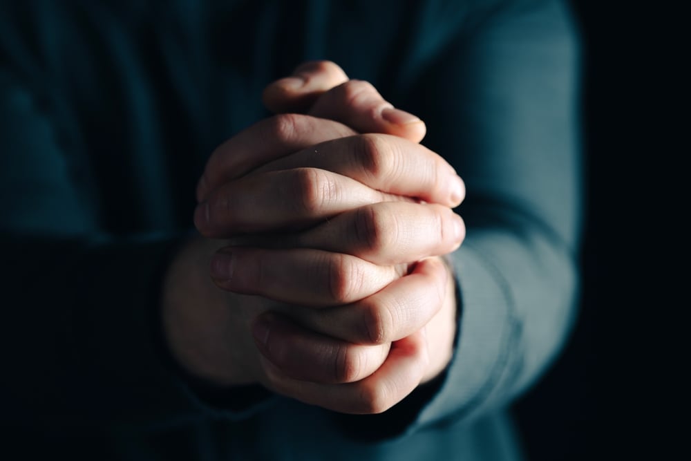Praying hands in faith.