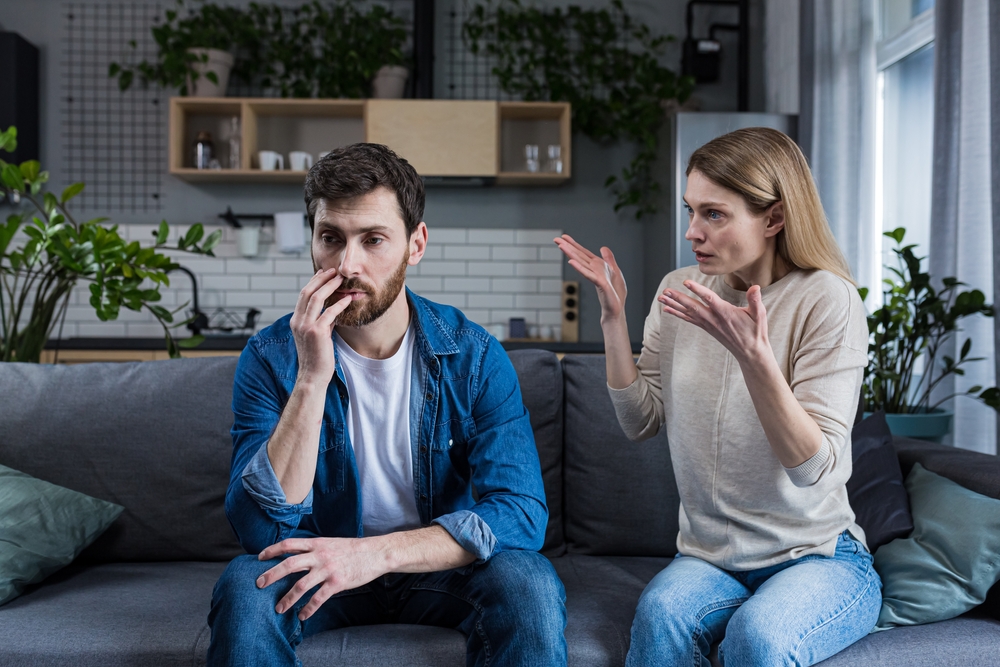 Man and woman quarreling with the woman talking and the man just staring into space