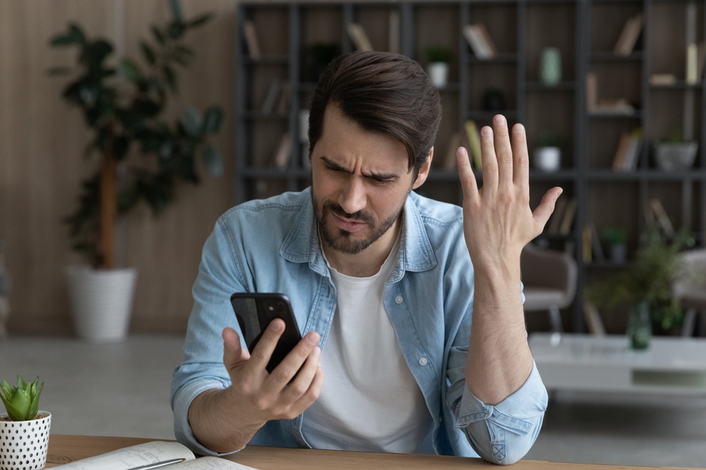 Arrogant angry man looking at his phone