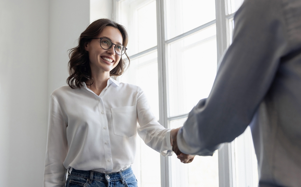 Young woman shaking hands at work