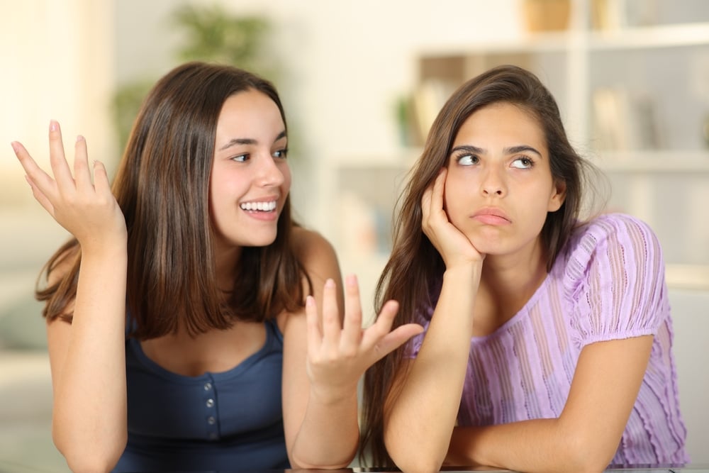 Woman ignoring the conversation of her friend at home