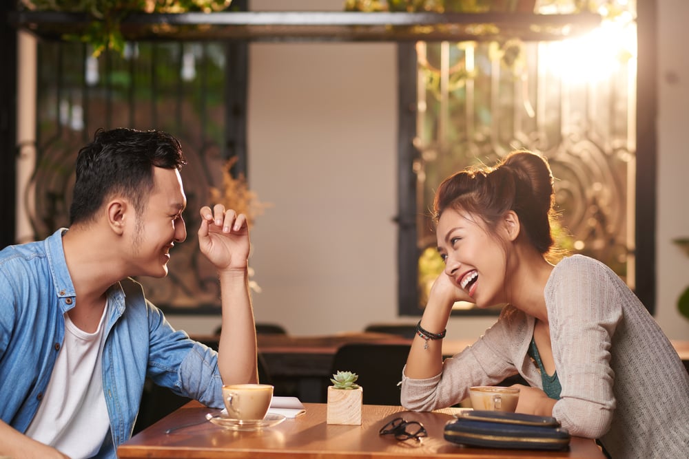 Side view of a young Asian couple enjoying their date