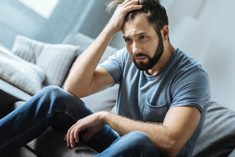 Man sitting alone looking lonely.