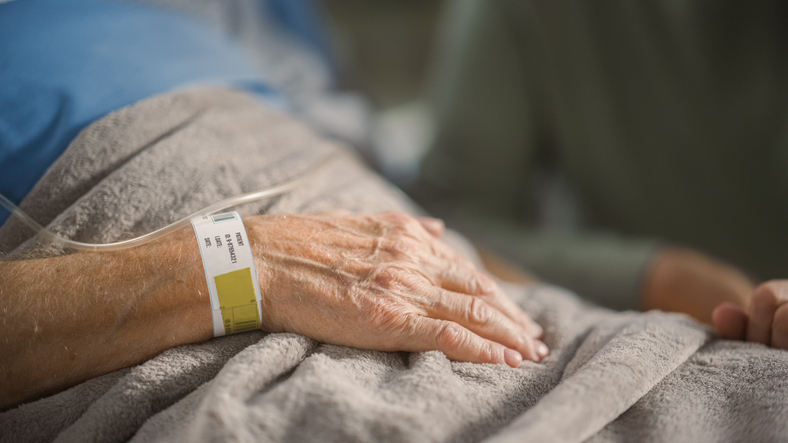 A hand with a hospital wrist band attached