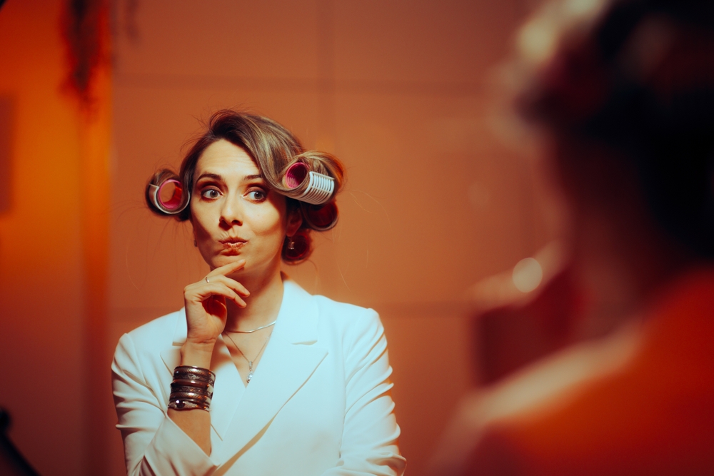 A woman with her hair in rollers puzzled over something