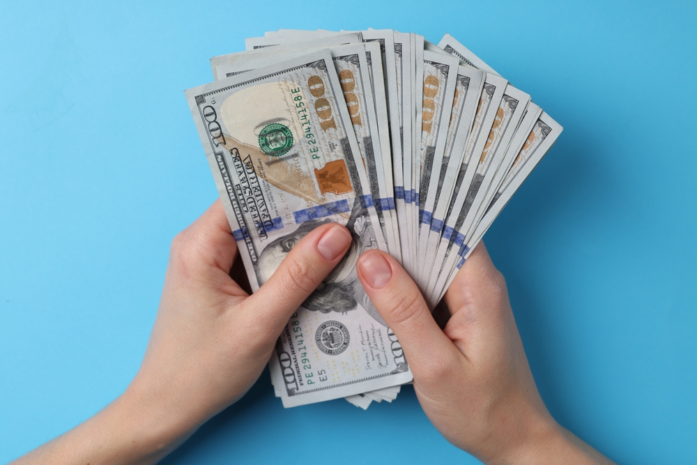 American money in someone's hands. 