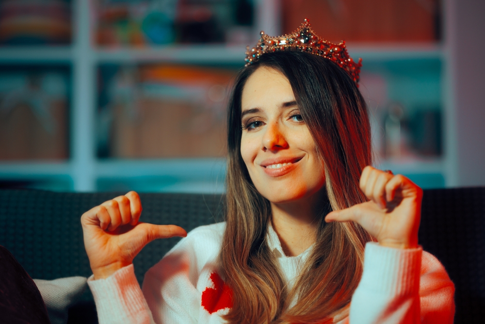 A woman wearing a crown, self absorbed and feeling self important