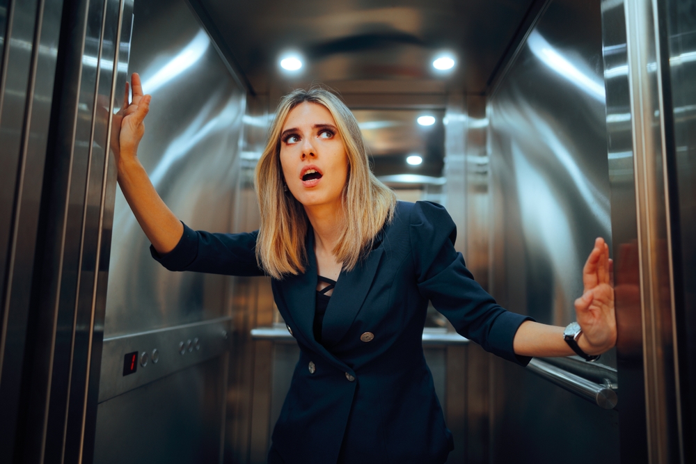 Stressed woman in an elevator.