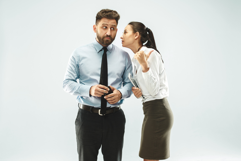 Two work colleagues gossiping
