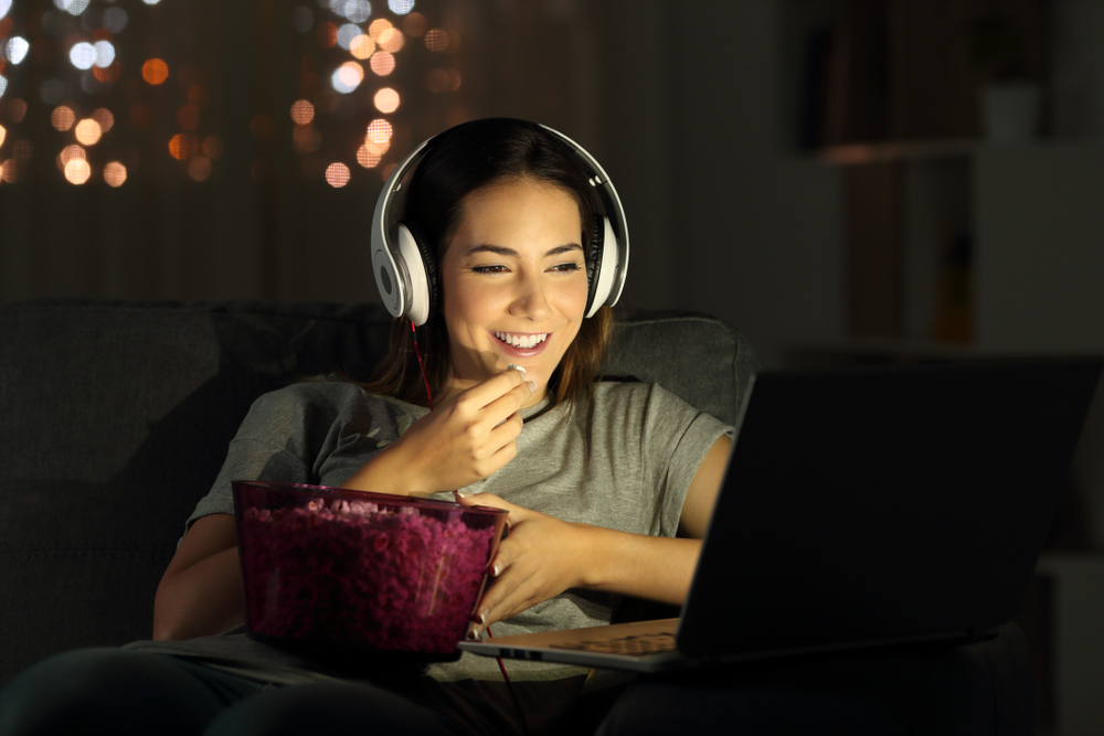 Woman watching TV on her computer.