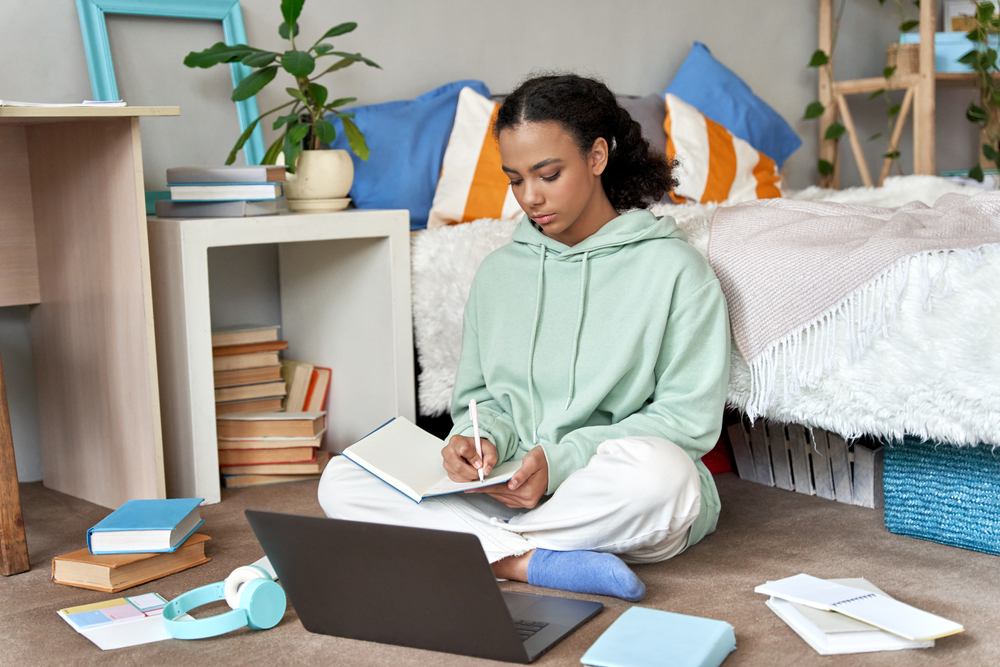 A young woman feeling anxious about the amount of schoolwork she has.