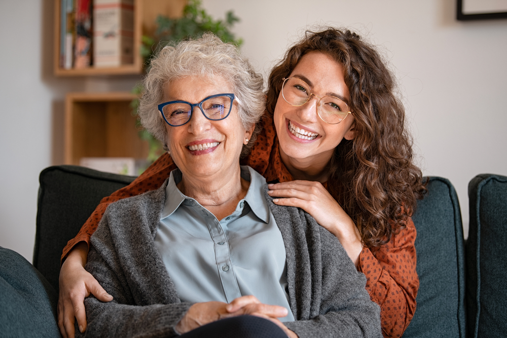 An elderly senior grandmother and her adult granddaughter