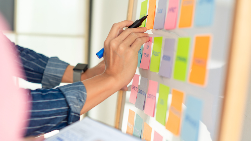 A man writing on post it notes