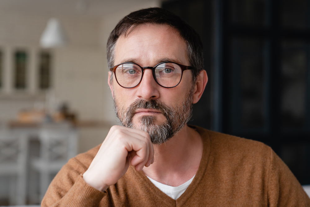Middle aged man in contemplation or deep in thought