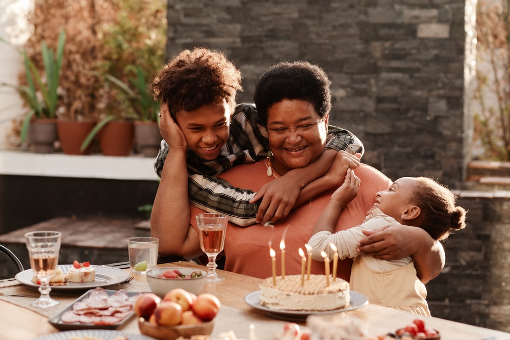A smiling and happy grandmother playing with her grandbabies