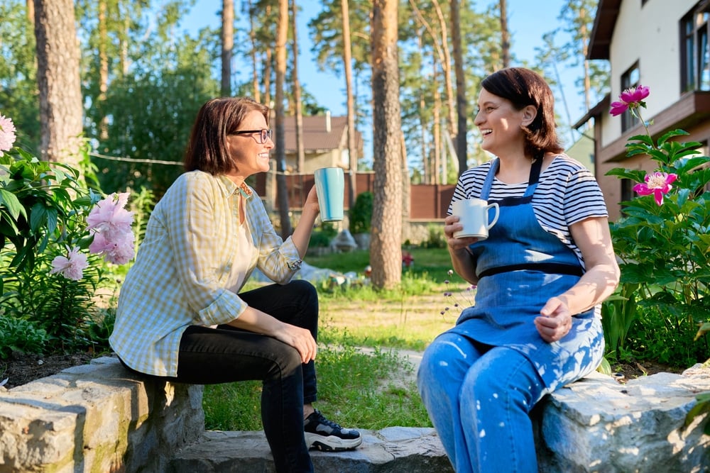 Two middle aged women having a discussion outside