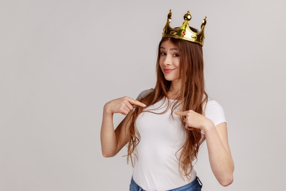 A selfish and egoistic young lady wearing a crown
