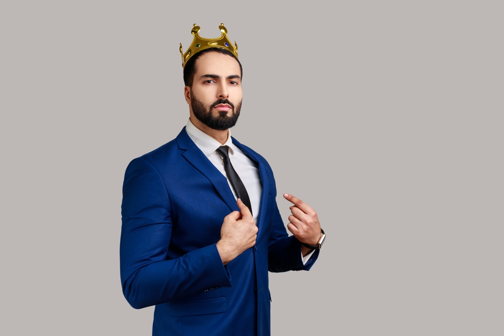 Arrogant narcissistic man wearing a crown