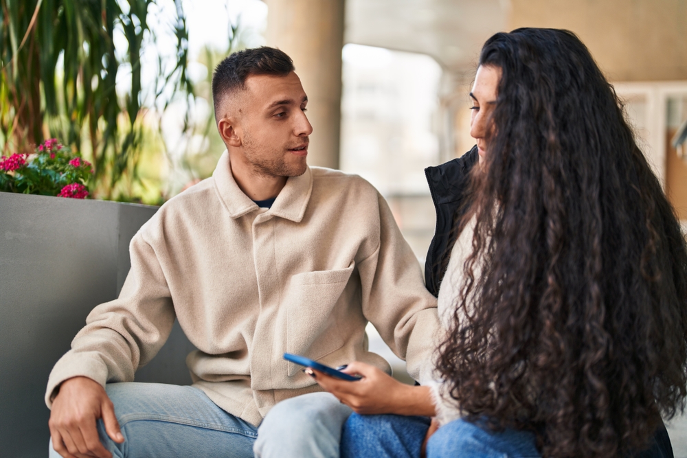 Man and woman smiling and talking to each other