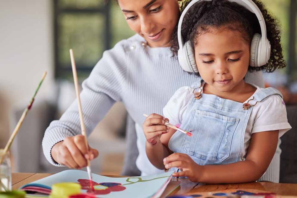 Mother and daughter painting together.